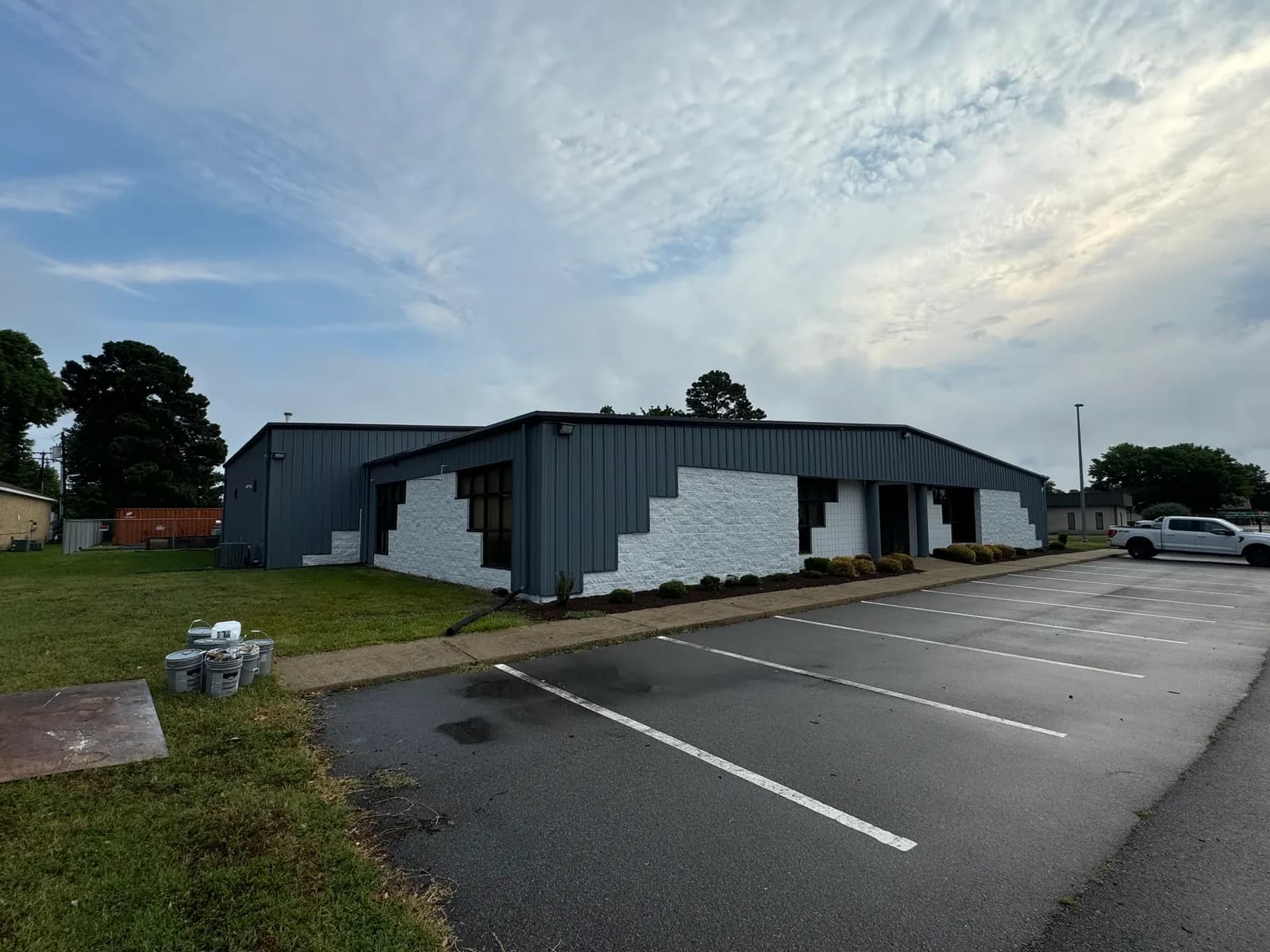 Commercial building with clean gray metal siding and white block walls